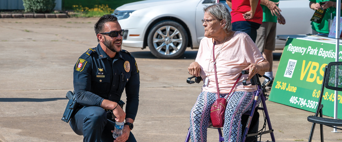 Officer talking to person in community.