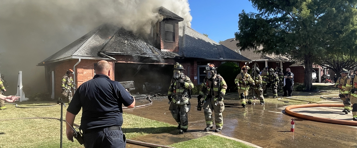 Firemen at scene of house fire.