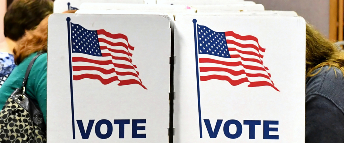 voting booths with people voting