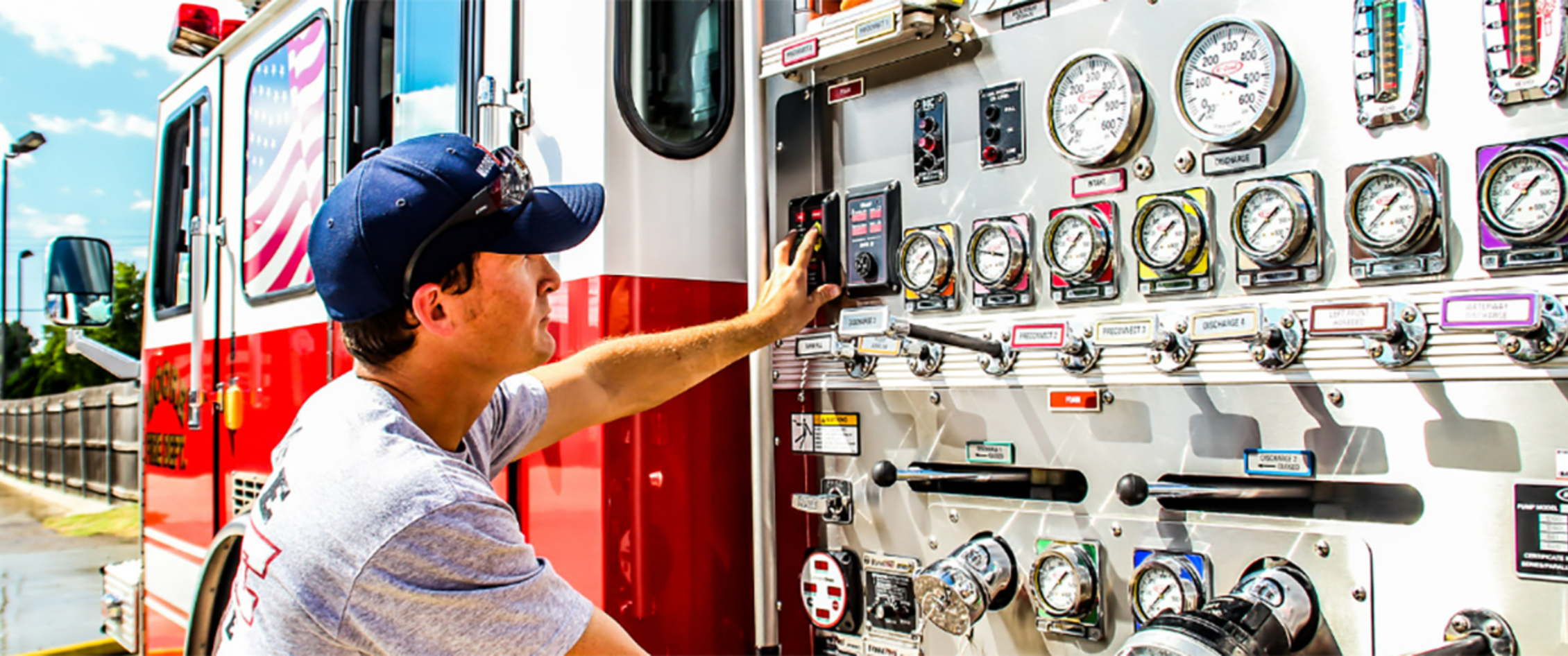 Fireman looking at gauges on fire truck.