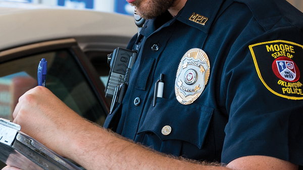 MPD officer writing ticket.